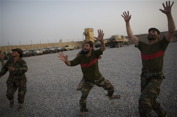 Afghan National Army soldiers play catch at Combat Outpost Terra Nova, in Kandahar, Afghanistan, Sunday, July 18, 2010. (AP Photo/Rodrigo Abd)